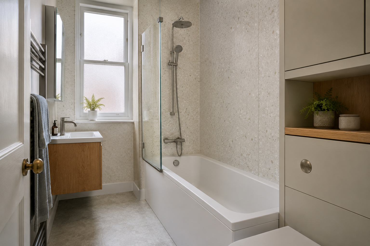 Fitted bath beside a vanity and recessed storage